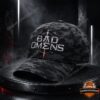 Bad Omens Dark Omen Camo Cap - full front view on a dark industrial stand