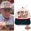 Buc-ee's Fresh Brisket On The Bone Flat Brim Snapback Cap - worn by a man while carving meat