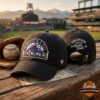 Colorado Rockies Live At Coors Field 2026 Baseball Hat - front and back view on wooden surface