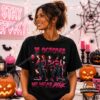 In October We Wear Pink Halloween Graphic T-Shirt - woman modeling black shirt with pink horror design