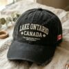 Lake Ontario We Hate Him Too Print Baseball Cap - front view and Canadian flag side patch