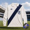 Retro Adidas style long sleeve polo shirt with diagonal stripe on a sports field