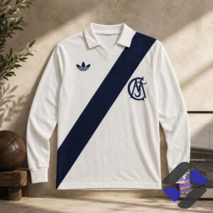 Close-up of the retro Adidas trefoil logo on the white polo shirt
