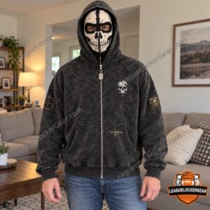 Man wearing the zip-up hoodie with the skull mask over his face at home