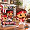 Patrick Mahomes No. 15 figure mid-throw beside its 100 Career Wins window box
