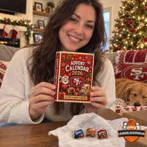 Fan smiling and holding the 49ers 2026 advent calendar in a living room