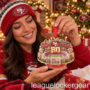 49ers 80th Anniversary Levi's Stadium Christmas Ornament - held by a fan in a 49ers beanie