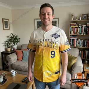 Man wearing the cream and gold Brewers Uecker jersey at home