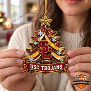 Hands holding the USC Trojans ornament with SC logo, football and gold star